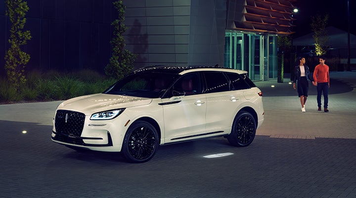 Two people approach a 2024 Lincoln Corsair® SUV featuring the available Jet Appearance Package. | Cummins Lincoln in Weatherford OK