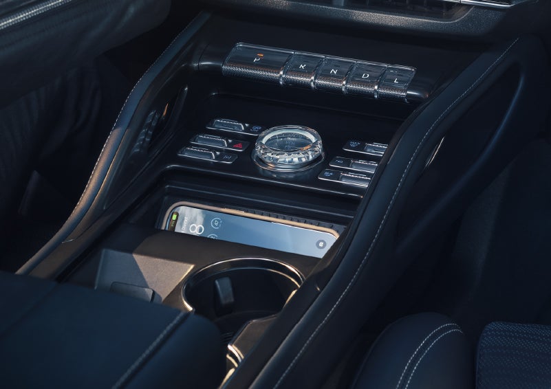 A smartphone is shown charging in the wireless charging pad. | Cummins Lincoln in Weatherford OK