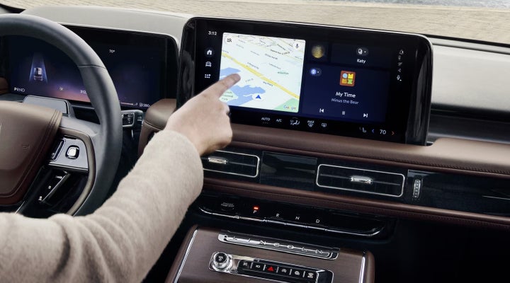 A person is tapping the center display touchscreen of a 2026 Lincoln Aviator® SUV. | Cummins Lincoln in Weatherford OK