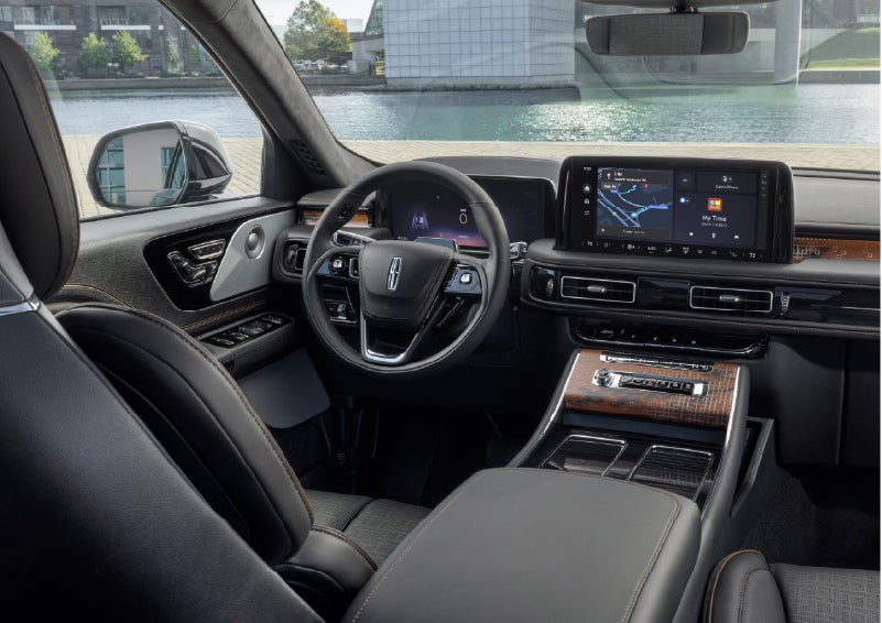 The interior of the 2026 Lincoln Aviator® SUV is shown parked with a view of a harbor through the windshield. | Cummins Lincoln in Weatherford OK