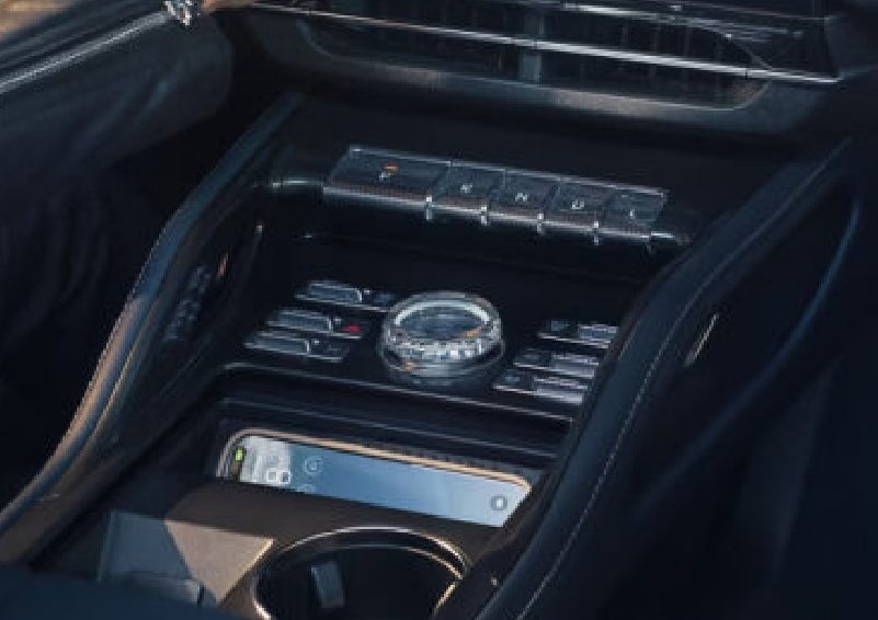 A smartphone is shown charging in the wireless charging pad. | Cummins Lincoln in Weatherford OK