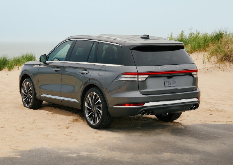 A 2027 Lincoln Aviator® SUV is parked next to sand dunes. | Cummins Lincoln in Weatherford OK