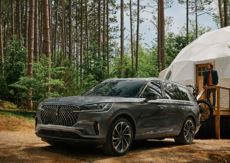 A 2027 Lincoln Aviator® is parked next to a high end glamping site. | Cummins Lincoln in Weatherford OK