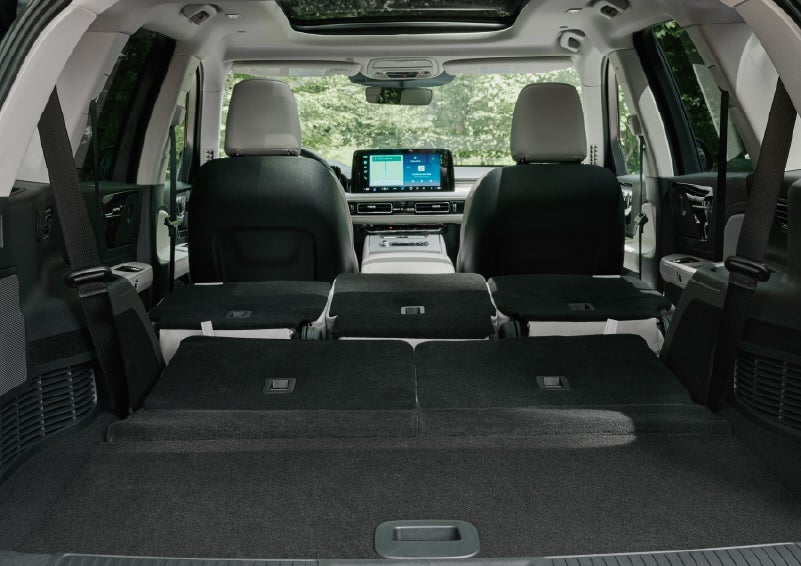 A rear to front view of the interior of a 2027 Lincoln Aviator® Black Label™ SUV shows the third and second rows folded flat | Cummins Lincoln in Weatherford OK