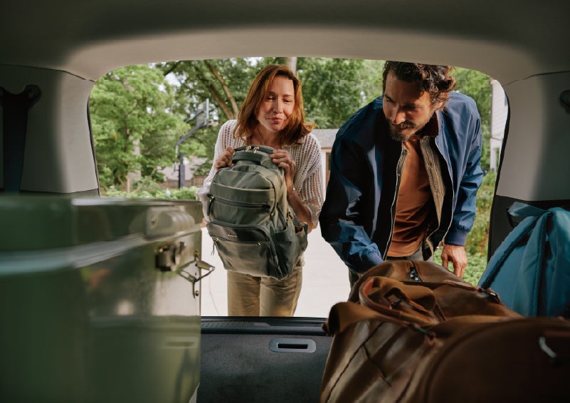 A couple loads luggage into the rear of a 2027 Lincoln Aviator® Black Label™ SUV..e 202 | Cummins Lincoln in Weatherford OK