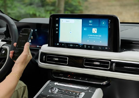 A person pairs thier phone with the center touchscreen of a 2027 Lincoln Aviator® Black Label™ SUV | Cummins Lincoln in Weatherford OK
